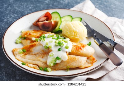 Fried Basa Fillet with sauce, mashed potato and fresh vegetables