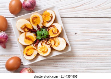 Fried Boiled Egg with Tamarind Sauce or Sweet and Sour Eggs - Shutterstock ID 1144354805