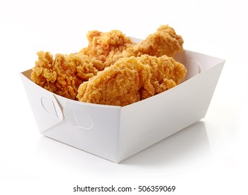 Fried breaded chicken fillet in white cardboard box isolated on white background