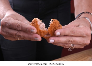 Fried and breaded codfish cake, fish empanadas, codfish cake, Brazilian-style codfish cakes, meat disc - Shutterstock ID 2323223817