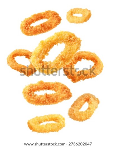 Fried breaded squid rings flying in air on white background