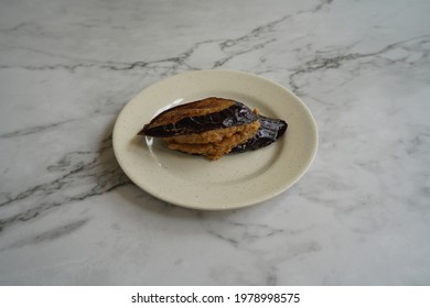 Fried Brinjal Stuffed With Fish Paste In A Plate