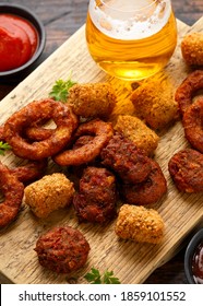 Fried Buffalo Onion Rings, Tater Tots And Sweetcorn Fritters With Ketchup And Beer. Party Take Away Food