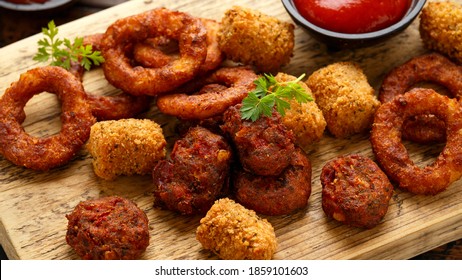 Fried Buffalo Onion Rings, Tater Tots And Sweetcorn Fritters With Ketchup And Beer. Party Take Away Food