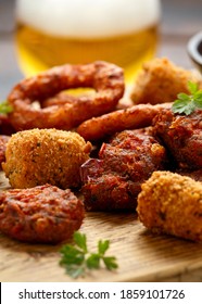 Fried Buffalo Onion Rings, Tater Tots And Sweetcorn Fritters With Ketchup And Beer. Party Take Away Food