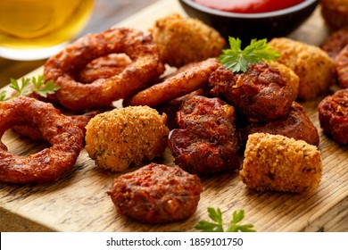 Fried Buffalo Onion Rings, Tater Tots And Sweetcorn Fritters With Ketchup And Beer. Party Take Away Food