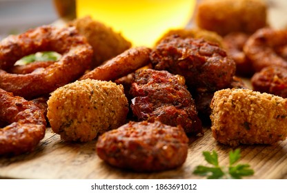 Fried Buffalo Onion Rings, Tater Tots And Sweetcorn Fritters With Ketchup And Beer. Party Take Away Food