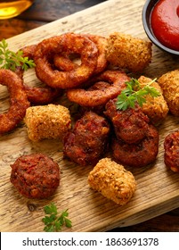 Fried Buffalo Onion Rings, Tater Tots And Sweetcorn Fritters With Ketchup And Beer. Party Take Away Food