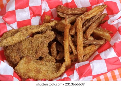 Fried Catfish Basket With French Fries in Rustic Cafe