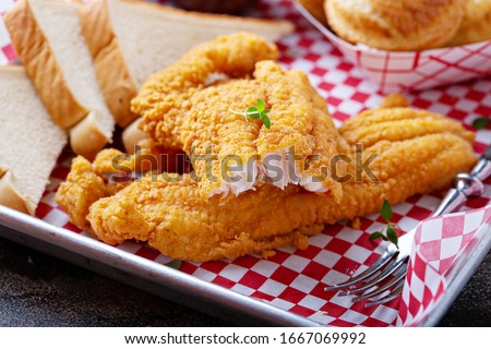 Fried catfish with cornbread dipped with buttermilk and seasoned with cornmeal, southern tradition