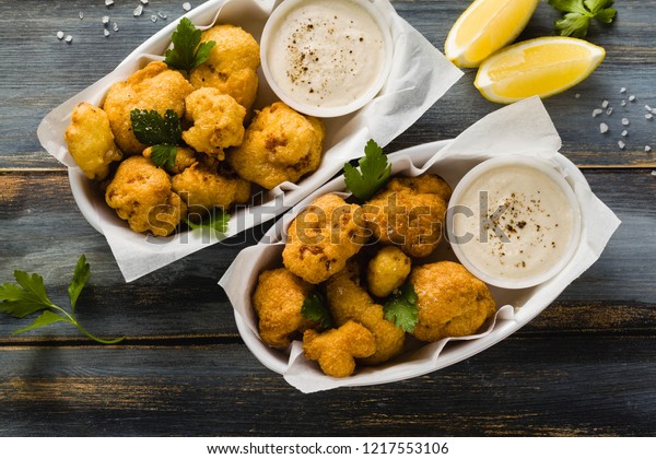 Fried cauliflower in batter with a savory\
sauce of cashew nuts. healthy vegan fast food. Baked Buffalo\
Cauliflower \