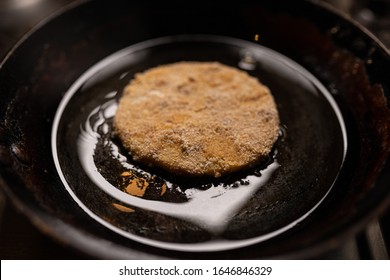 Fried Celeriac In Dark Iron Ladle