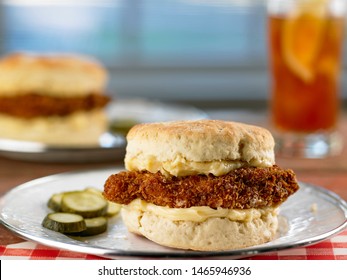 Fried Chicken And Biscuits Sandwich On Plate With Pickles
