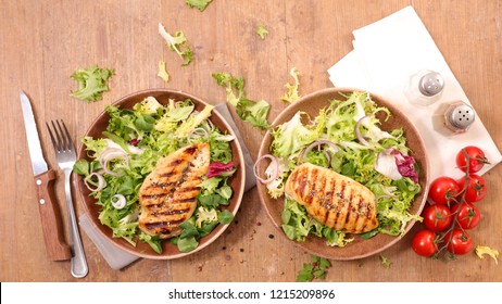 fried chicken breast with salad - Shutterstock ID 1215209896