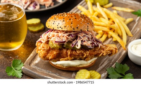 Fried Chicken Burger, Sandwich With Coleslaw, Pickled Gherkins, Mayonnaise And Beer. Fast Food.