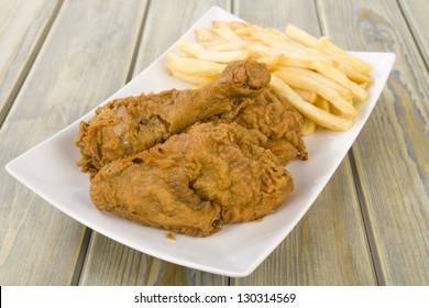 Fried Chicken & Chips - Chicken Pieces On The Bone Coated In A Spicy Flour And Deep Fried Served With Fries.