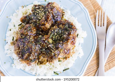 Fried Chicken Covered In Garlic Teriyaki Sauce And Sprinkled With Furikake On A Bed Of Rice