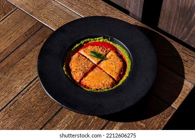 Fried Chicken Cutlet With Basil And Pea Sauce In A Plate Standing On The Table