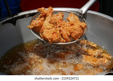  Fried chicken in deep fry outdoor  - Shutterstock ID 2159224711
