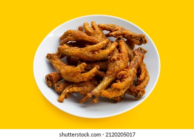 Fried Chicken Feet In White Plate On Yellow Background.