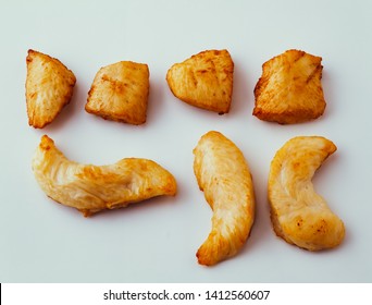 Fried chicken fillet cubes and strips isolated on white background