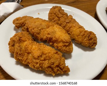 Fried Chicken fingers on a plate - Shutterstock ID 1568740168