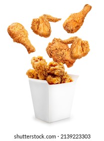 Fried chicken flying out of paper bucket isolated on white background, Fried chicken on white With clipping path. - Shutterstock ID 2139223303