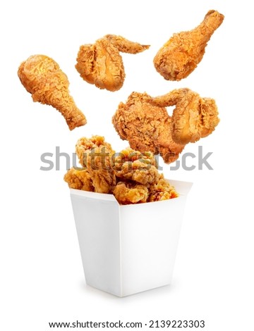 Fried chicken flying out of paper bucket isolated on white background, Fried chicken on white With clipping path.