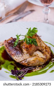 Fried Chicken Half With Parsley, Mung Bean Salad And Pesto Sauce On A White Round Plate. Vertical Orientation