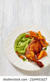 Fried Chicken Leg With Guasacaca Sauce Of Avocado, Green Pepper And Herbs And Sweet Potato Chips On White Plate On Wooden Table, Vertical View From Above