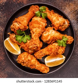 Fried Chicken Legs With Lemon And Parsley. Top View