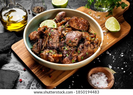 Fried chicken liver with onions and herbs. 