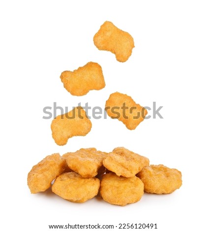 Fried chicken nuggets falling in the air isolated on white background