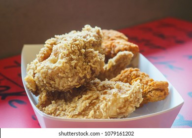 Fried chicken on red table.