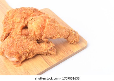 Fried chicken on wooden board isolated on white background.