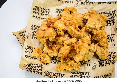 Fried Chicken Popcorn KFC Style.crispi And Testy Hot Crispy Snack With Oill Paper On White And Black Background.