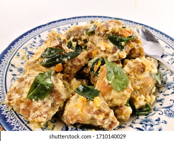Fried chicken with salted egg in blue ceramic plate isolated with white. Selective focus. - Shutterstock ID 1710140029