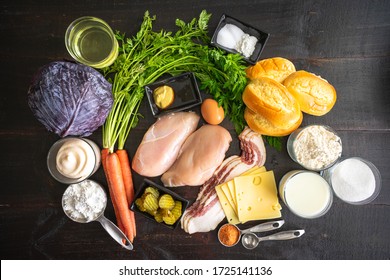 Fried Chicken Sandwich With Tangy Slaw Ingredients: Raw Chicken Breasts, Vegetables, And Other Ingredients On A Dark Wood Background