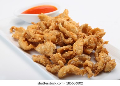 Fried Chicken Skin Served On White Dish 