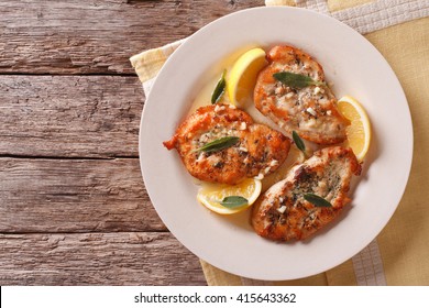 Fried Chicken Steaks With Sage, Garlic And Butter On A Plate Horizontal Top View
