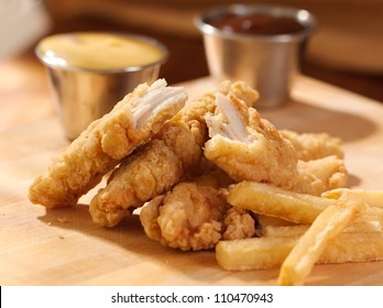 Fried Chicken Strips With French Fries And Sauce.