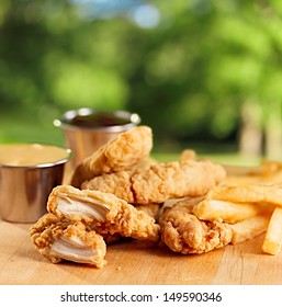 Fried Chicken Strips With French Fries And Sauce.