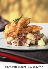 Fried Chicken Tenders On Mashed Red Potatoes.