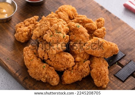Fried chicken tenders or strips served with ketchup and fries Stock foto © 