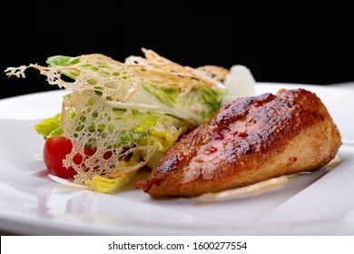 Fried chicken with vegetables, on a white plate. White background.