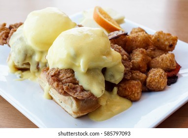 Fried Chicken And Waffles Along With Eggs Benedict And Hollandaise Sauce For Brunch