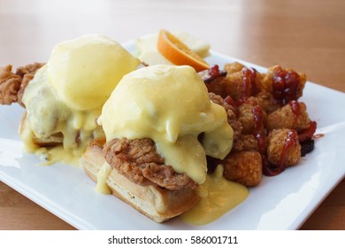 Fried Chicken With Waffles And Eggs Benedict With Hollandaise Sauce For Brunch