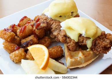 Fried Chicken With Waffles And Eggs Benedict With Hollandaise Sauce For Brunch