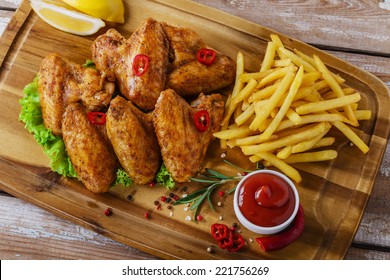 Fried Chicken Wings With Red Sauce And French Fries