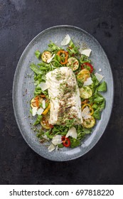 Fried Cod Fish Fillet With Lettuce And Vegetable As Top View On A Plate